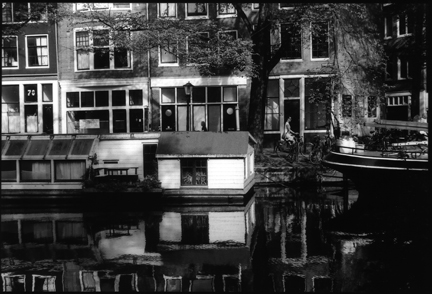 canal boat and bicyclist in amsterdam